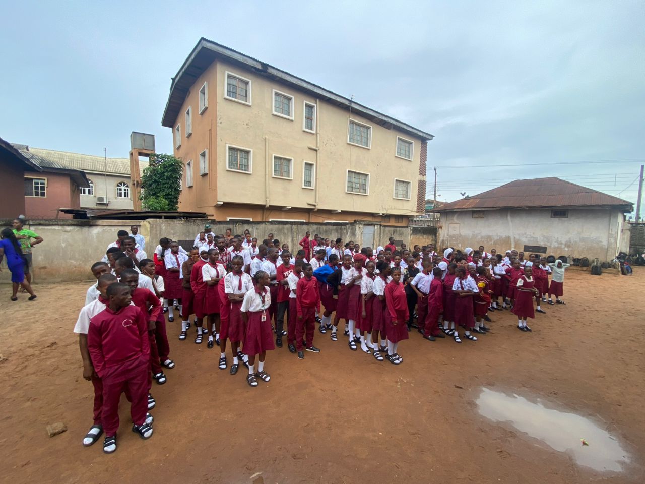 Large group of students gathered in the school courtyard for morning assembly